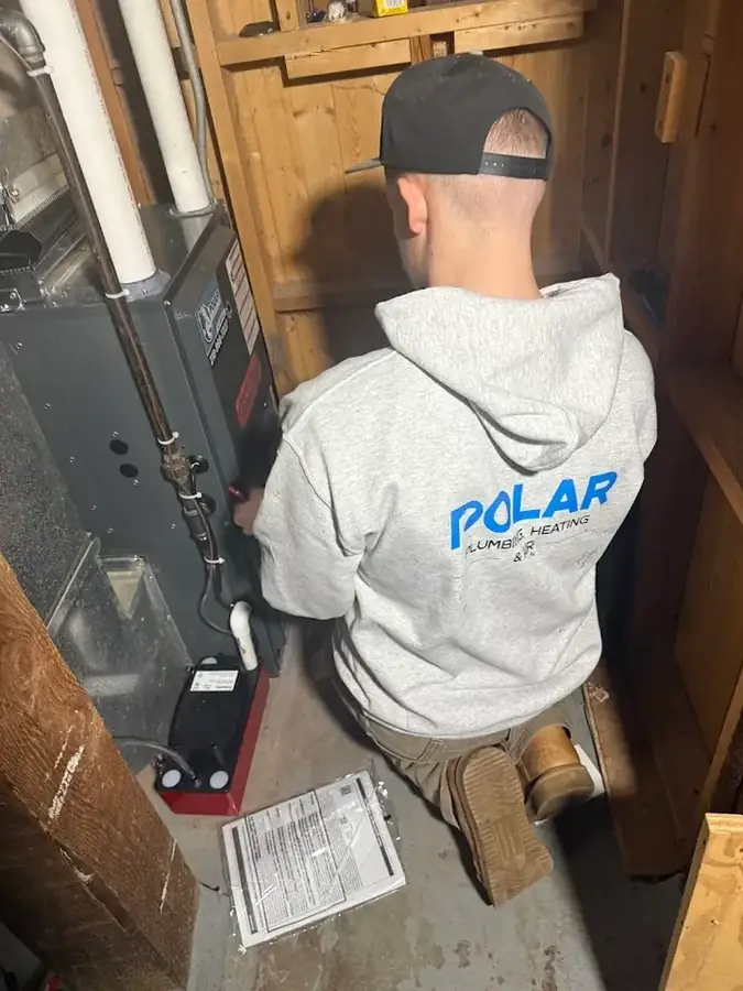 Polar technician installing a high-efficiency furnace