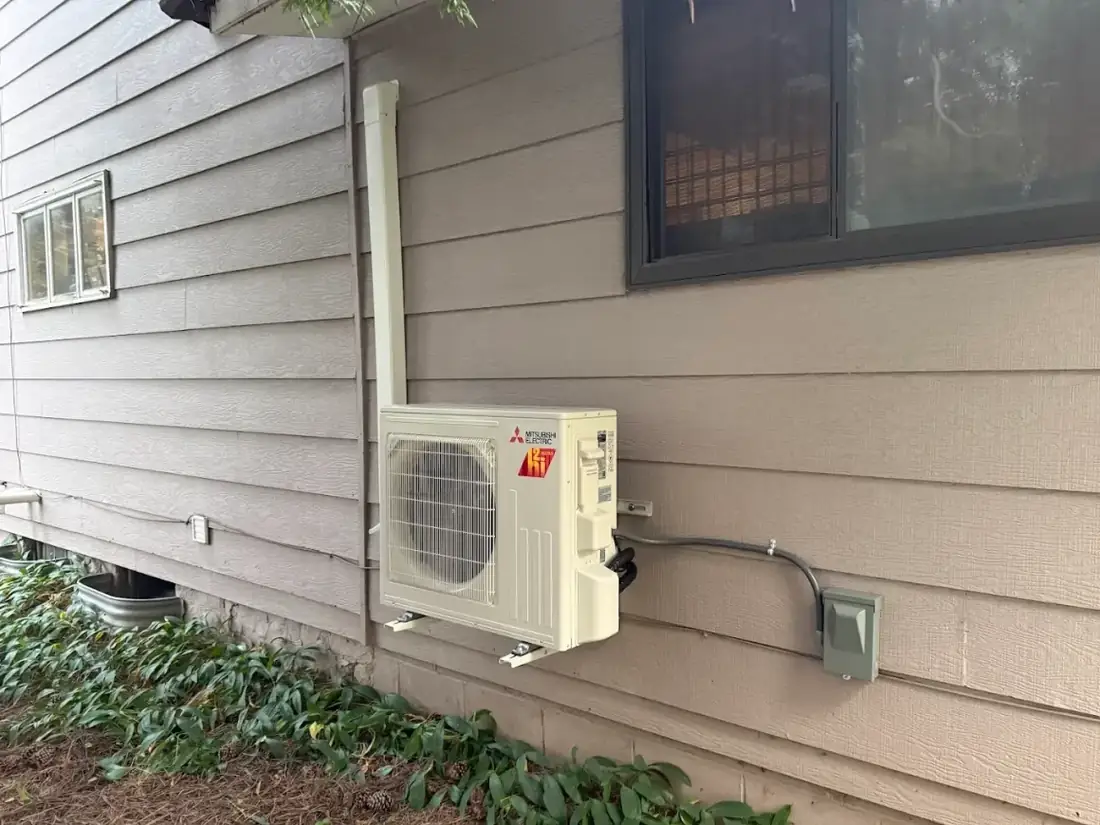 Ductless mini-split outdoor unit installed on a home exterior