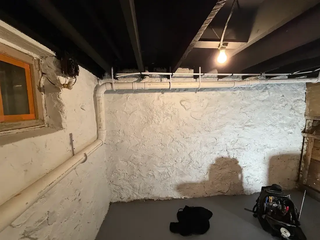 New drain line neatly installed in an older Duluth basement